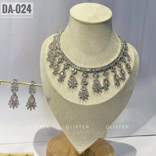 Silver-tone necklace and earrings with pink accents and a decorative fringe on a display bust