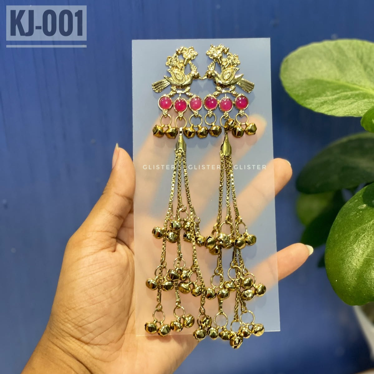 Glister KJ-001: A pair of Kashmiri-inspired long earrings with peacock-inspired tops and round colored accents, hanging chains and clusters of small bell-like drops.
