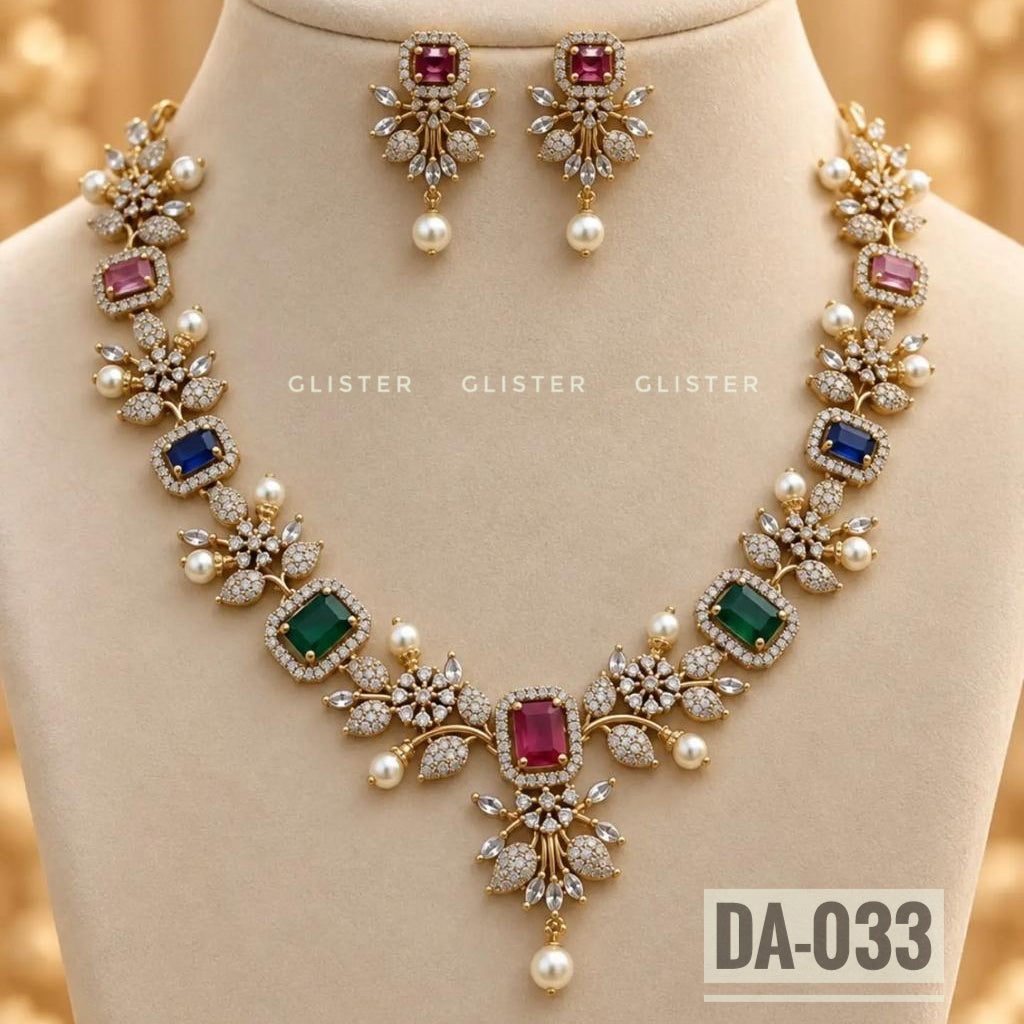 Gold-tone floral necklace with multicolor accents and matching earrings on a cream bust