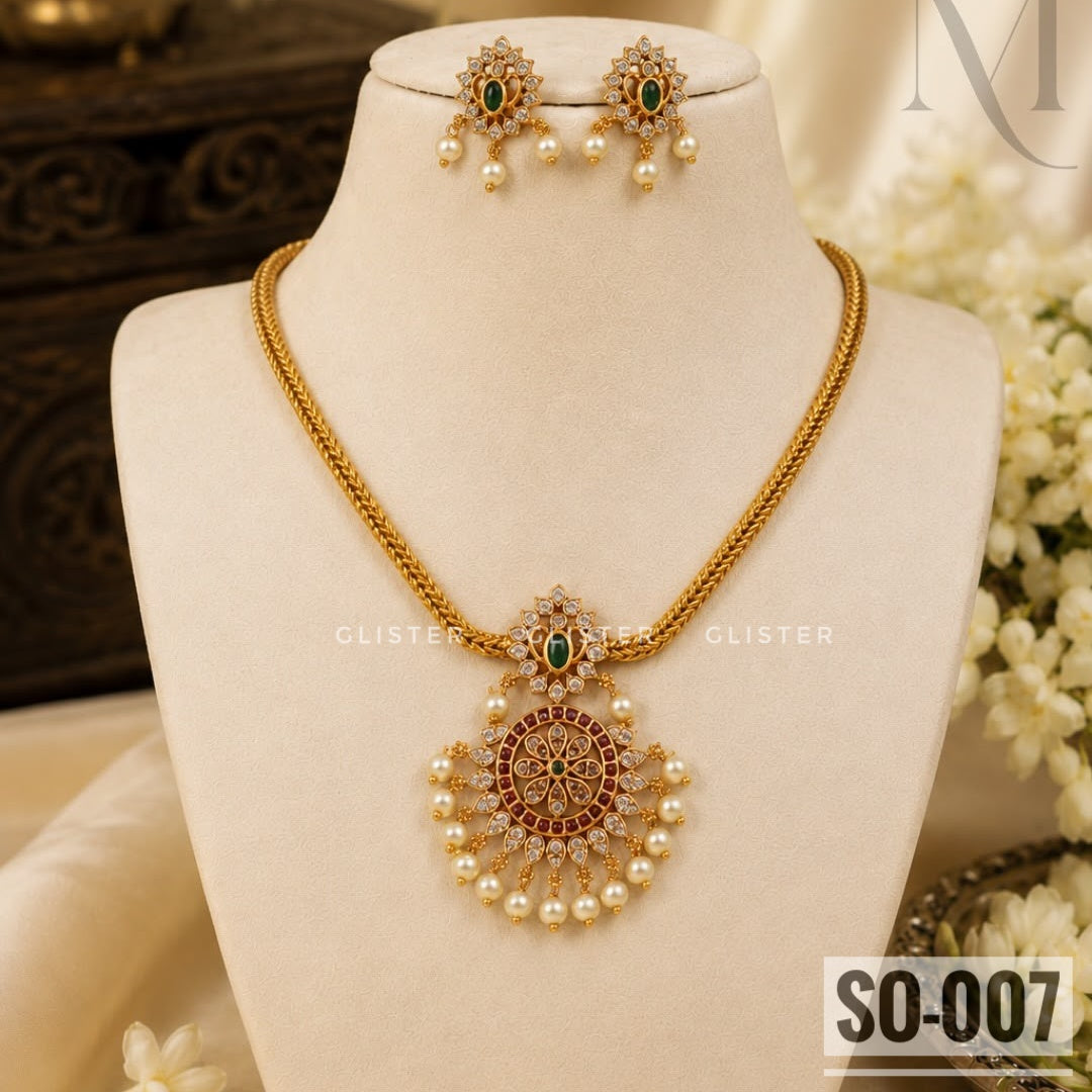 Gold-tone necklace jewellery with an ornate pendant and white bead drops. SO-007.