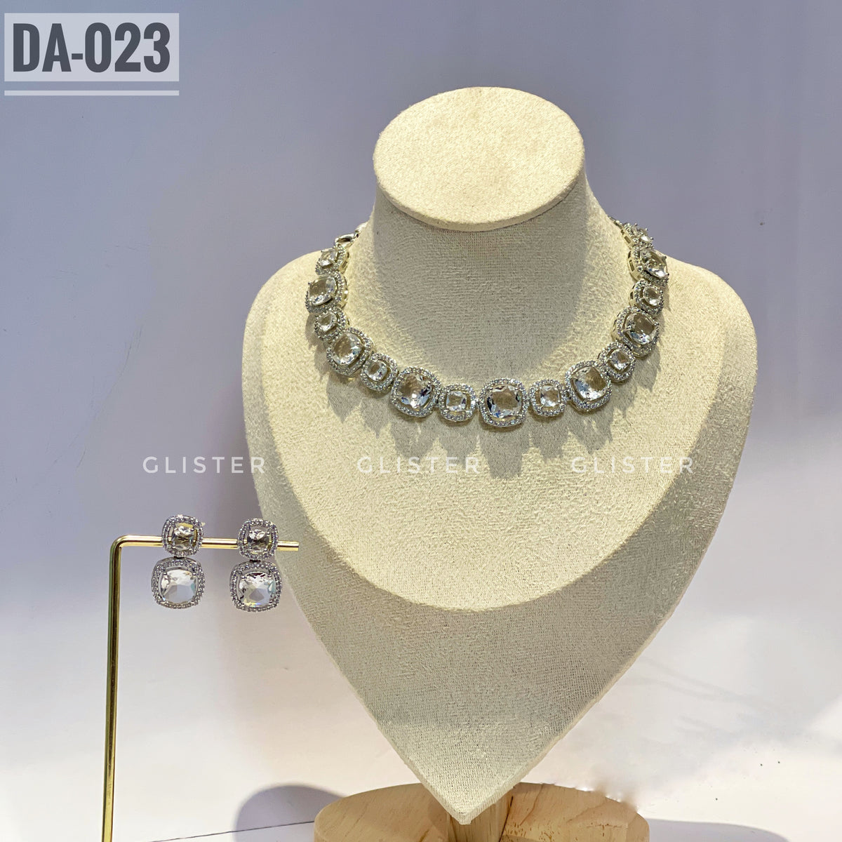 Silver-tone square-accent necklace and matching drop earrings on a display bust