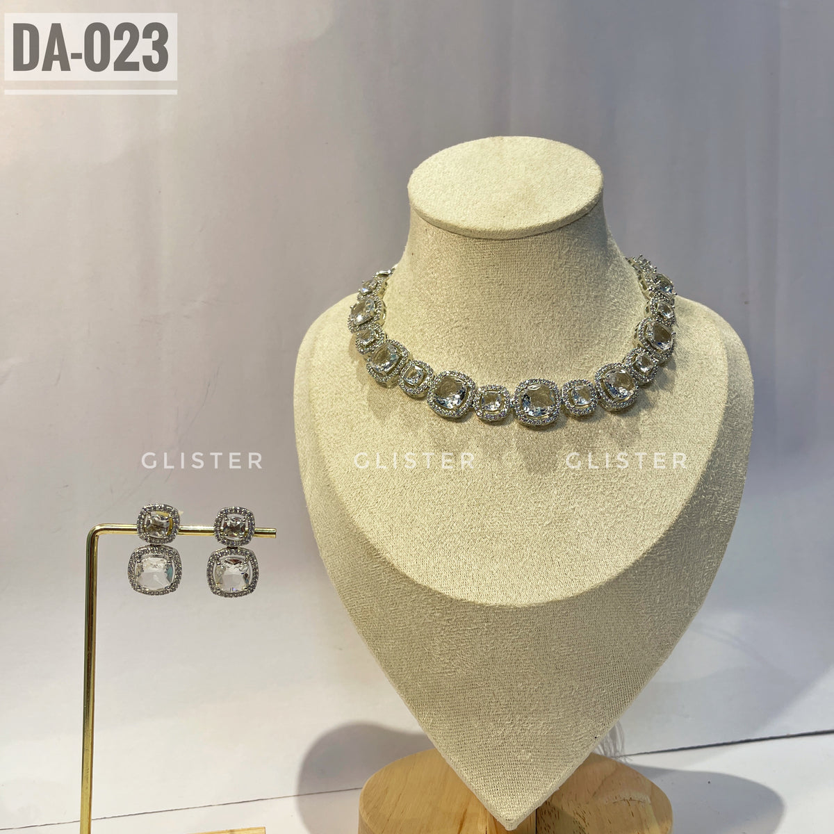 Silver-tone square-accent necklace and matching drop earrings on a display bust