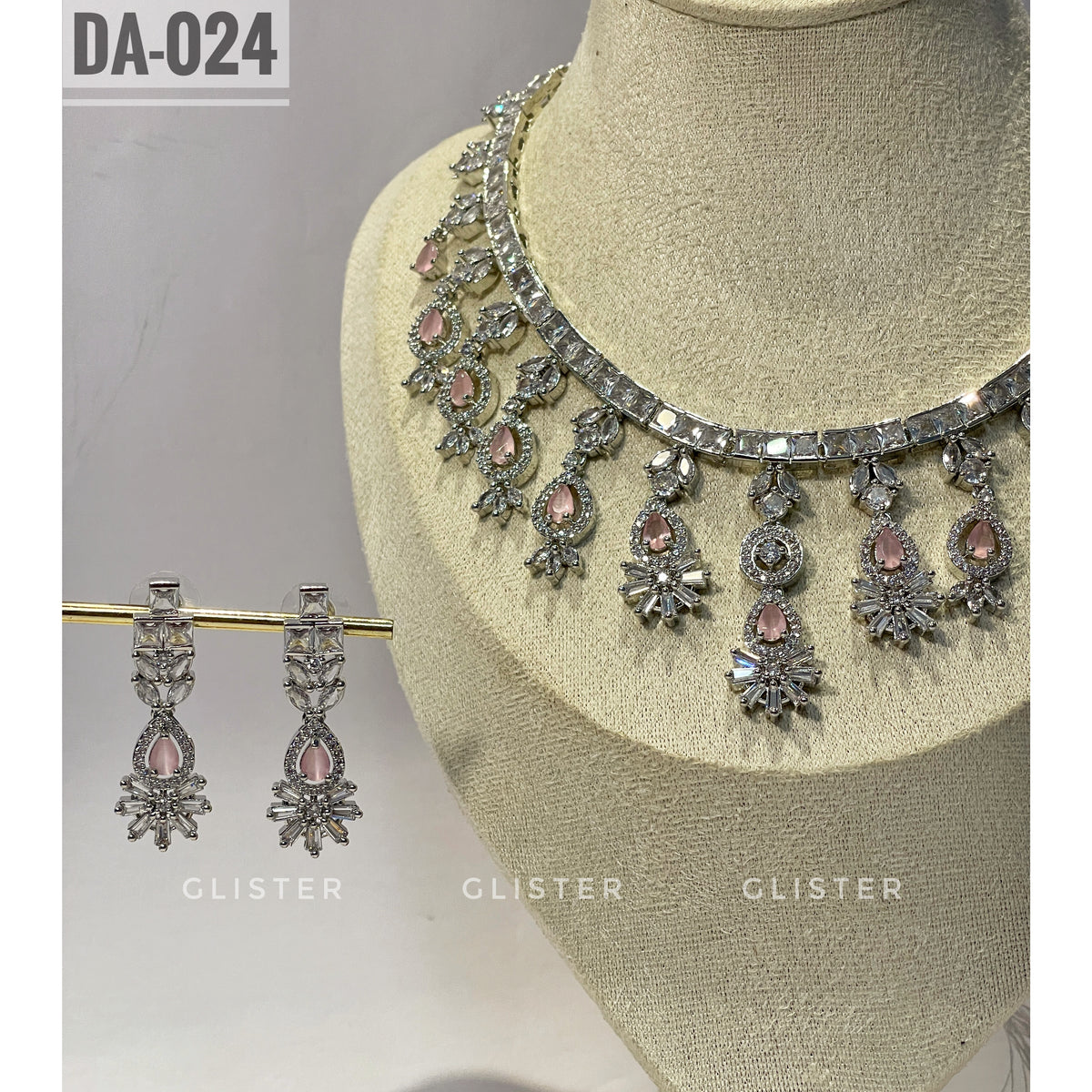 Silver-tone necklace and earrings with pink accents and a decorative fringe close-up on a display bust