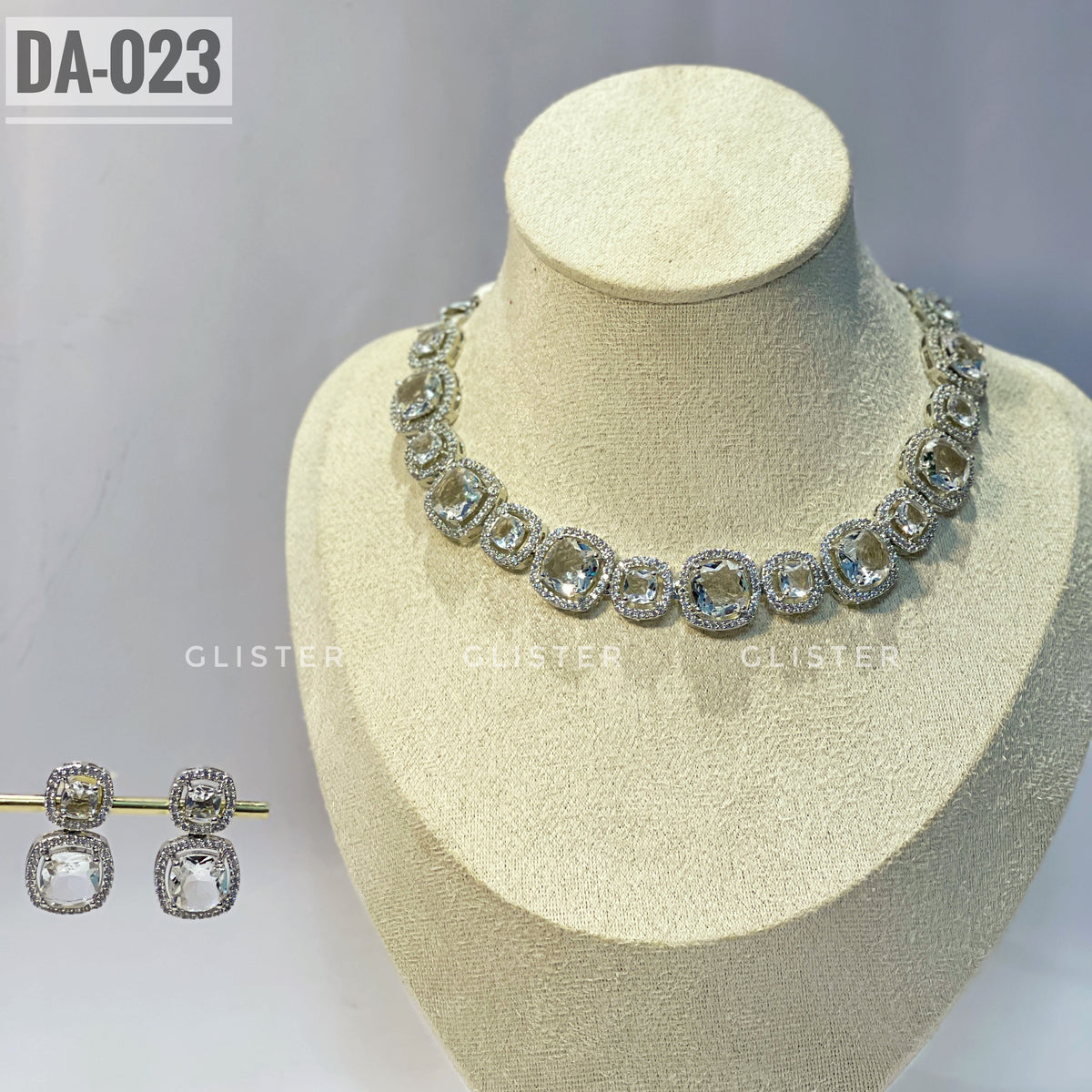 Silver-tone square-accent necklace and matching drop earrings on a display bust
