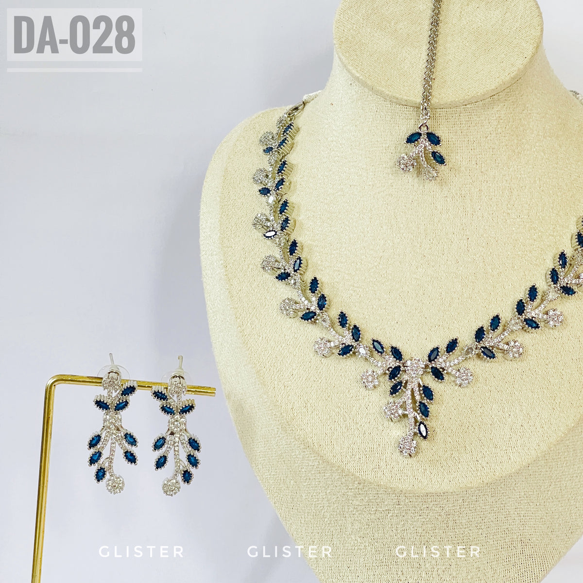 Silver-tone dark blue leaf necklace and earrings close-up with a matching forehead ornament