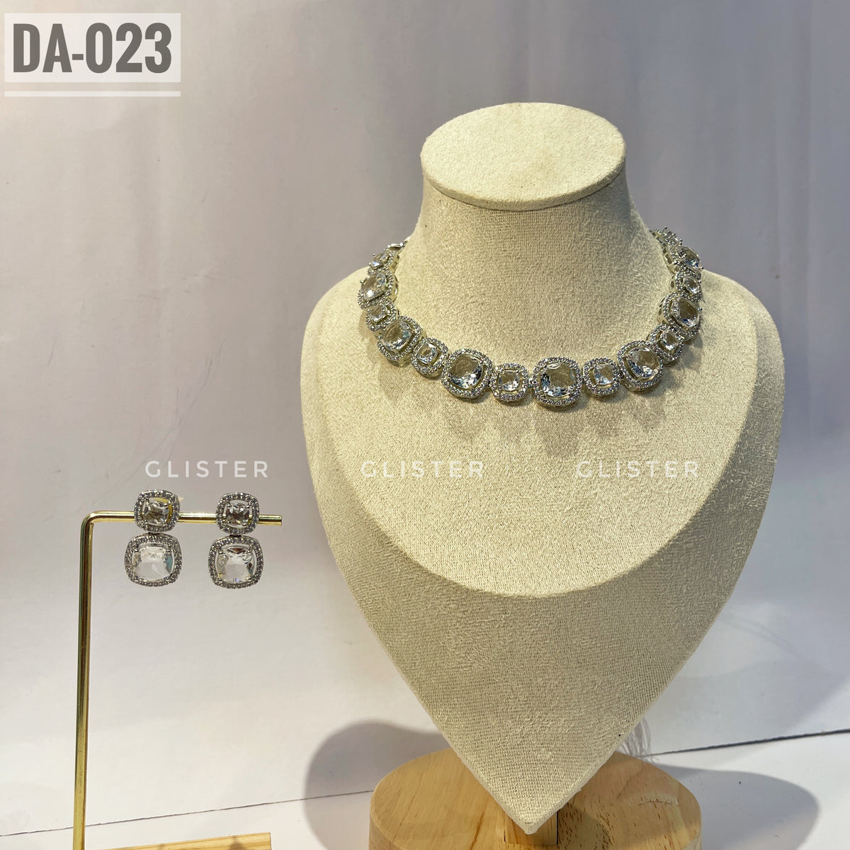Silver-tone square-accent necklace and matching drop earrings on a display bust