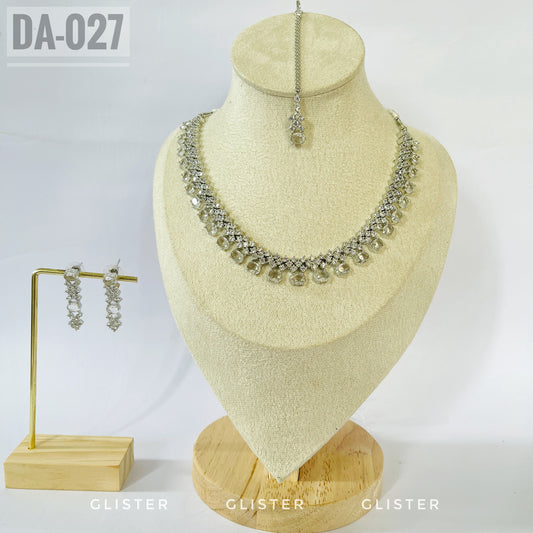 Silver-tone clear teardrop necklace and earrings on a bust with a matching forehead ornament