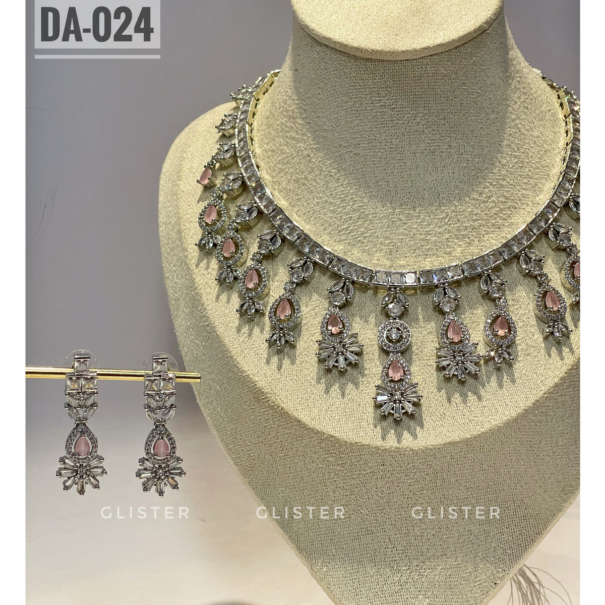 Silver-tone necklace and earrings with pink accents and a decorative fringe close-up on a display bust