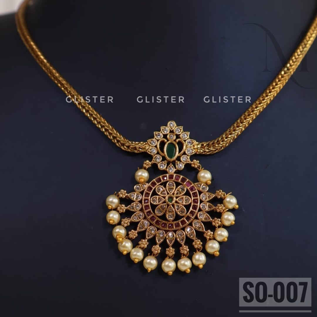 Gold-tone necklace jewellery with an ornate pendant and white bead drops. SO-007.
