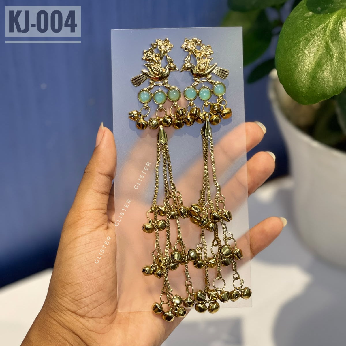 Glister KJ-004: A pair of Kashmiri-inspired long earrings with peacock-inspired tops and round colored accents, hanging chains and clusters of small bell-like drops.