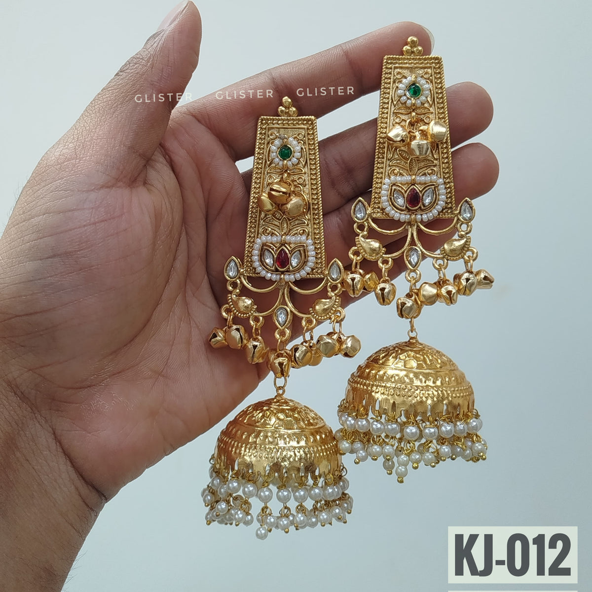 Glister KJ-012: Long rectangular earrings with raised floral detailing, small hanging charms and large bell-shaped drops edged with white beads.