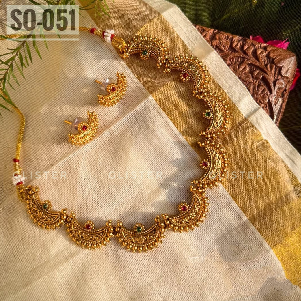 Gold-tone crescent-motif necklace with red and green accents and matching studs. SO-051.