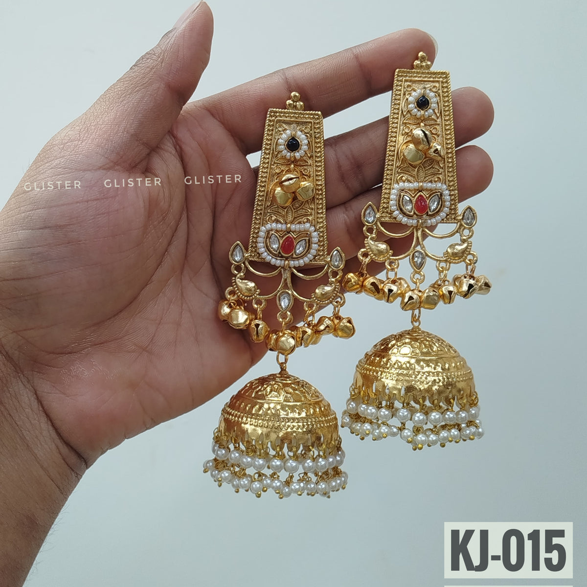 Glister KJ-015: Long rectangular earrings with dark floral accents, small hanging charms and large bell-shaped drops edged with white beads.